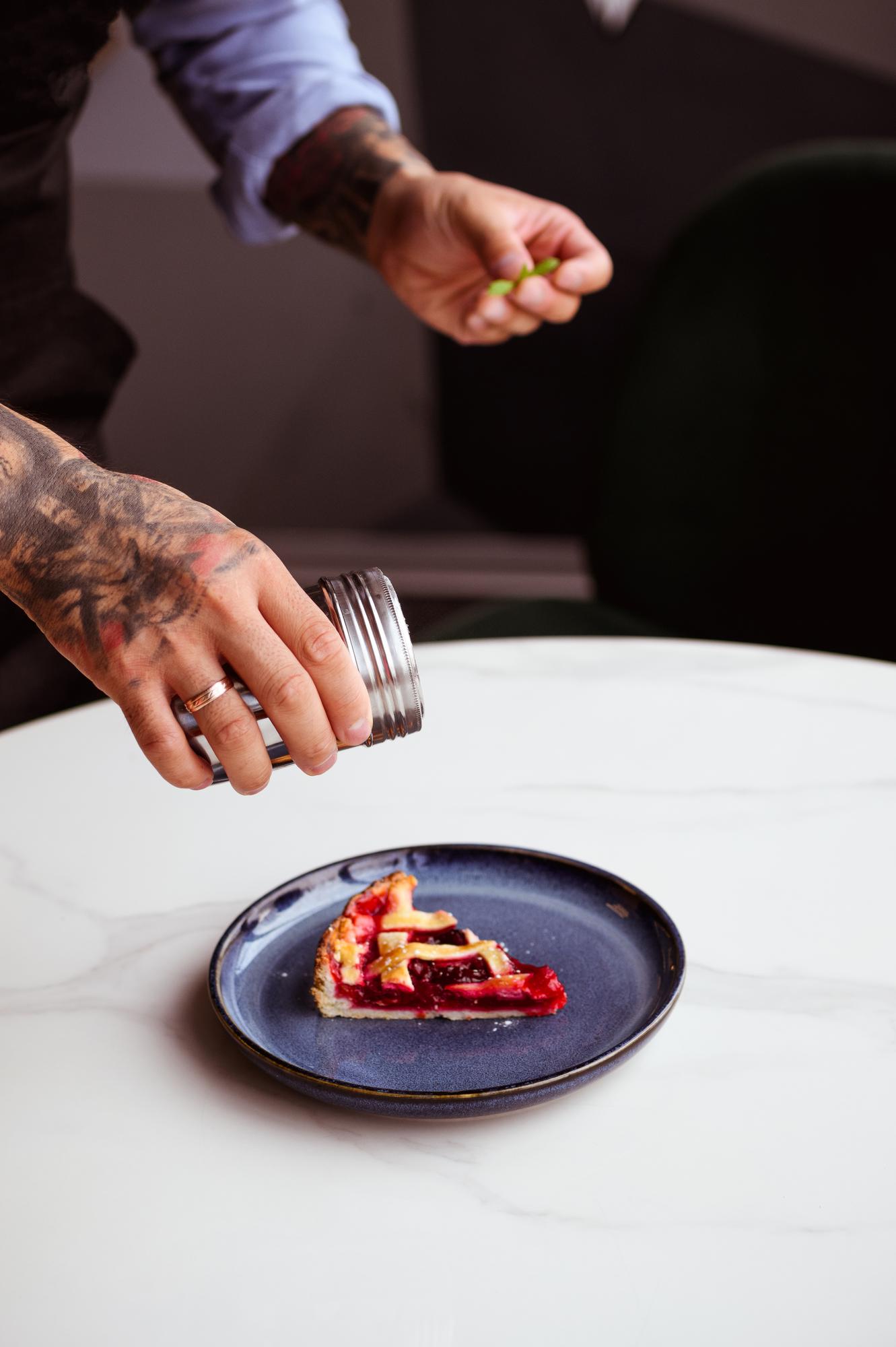 Chef plating an elegant dish in a studio kitchen